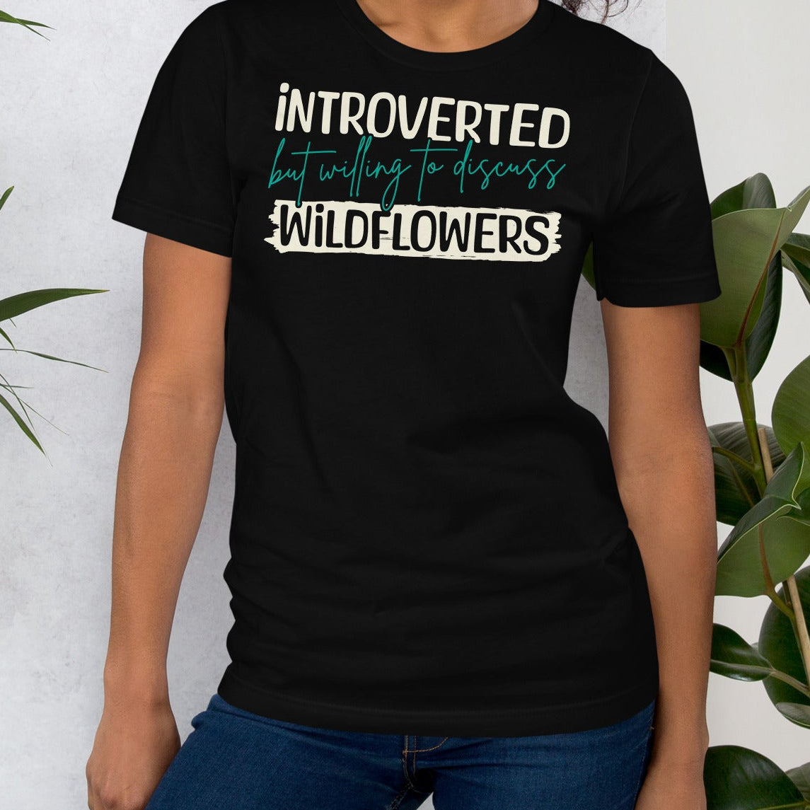 Black t-shirt with text 'introverted but willing to discuss wildflowers'.