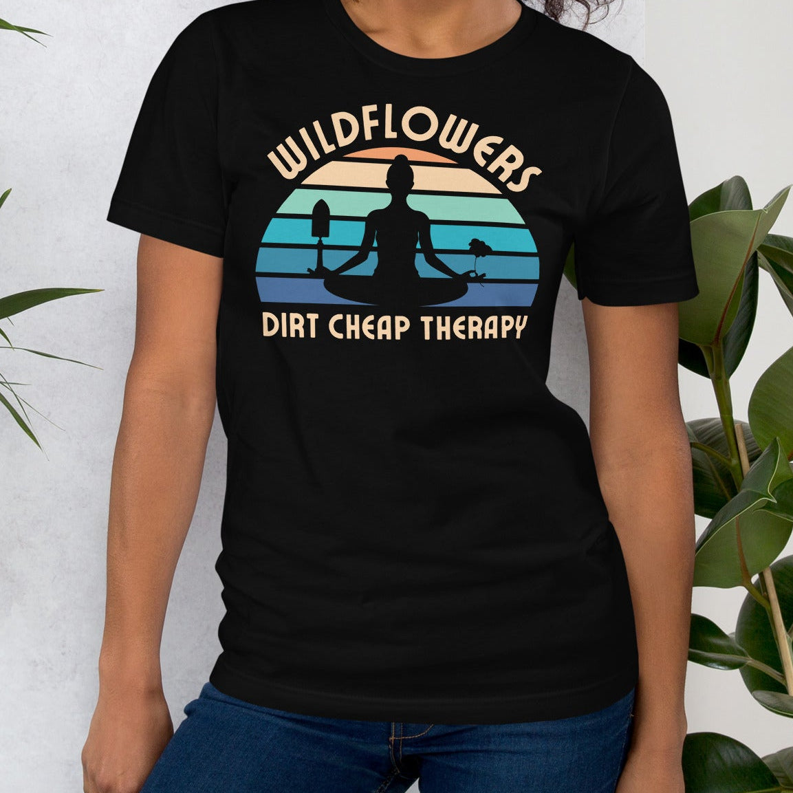 Black t-shirt with a graphic design and text 'wildflowers dirt cheap therapy'.
