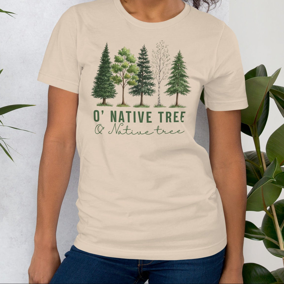 Beige t-shirt with native trees design and text.