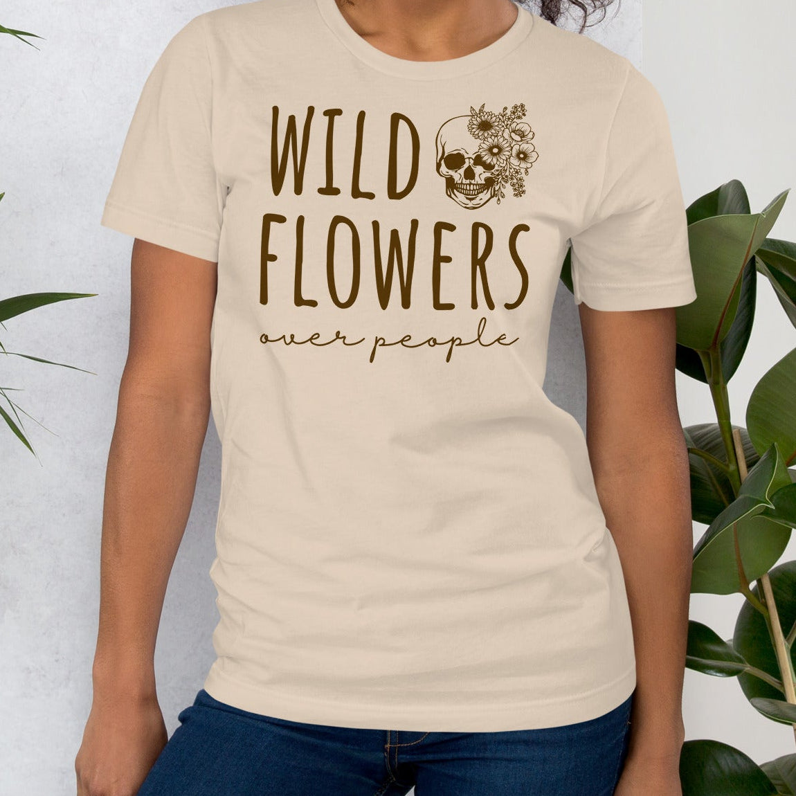 Beige t-shirt with 'Wild Flowers Over People' text and skull graphic.